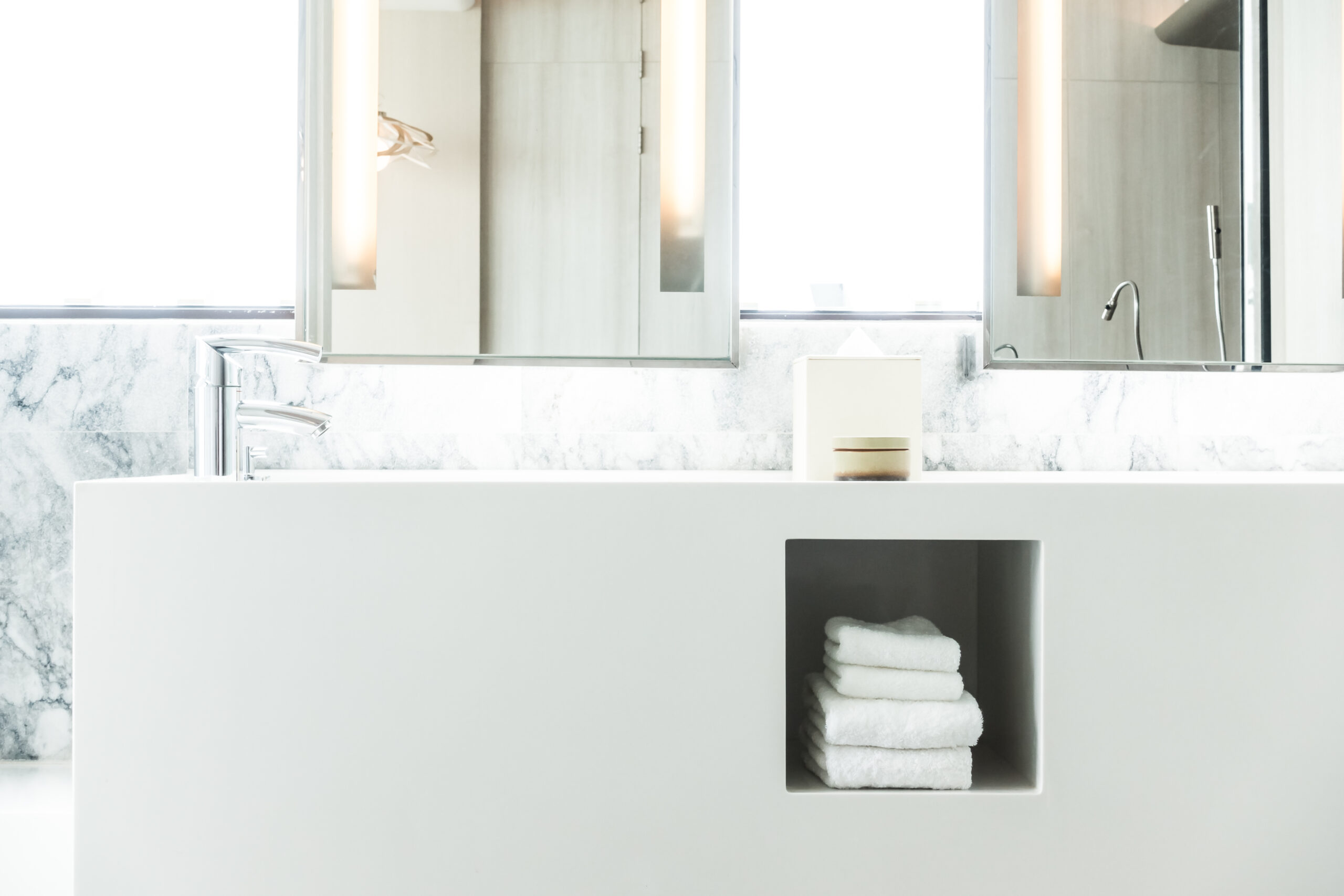 white porcelain sink with towels